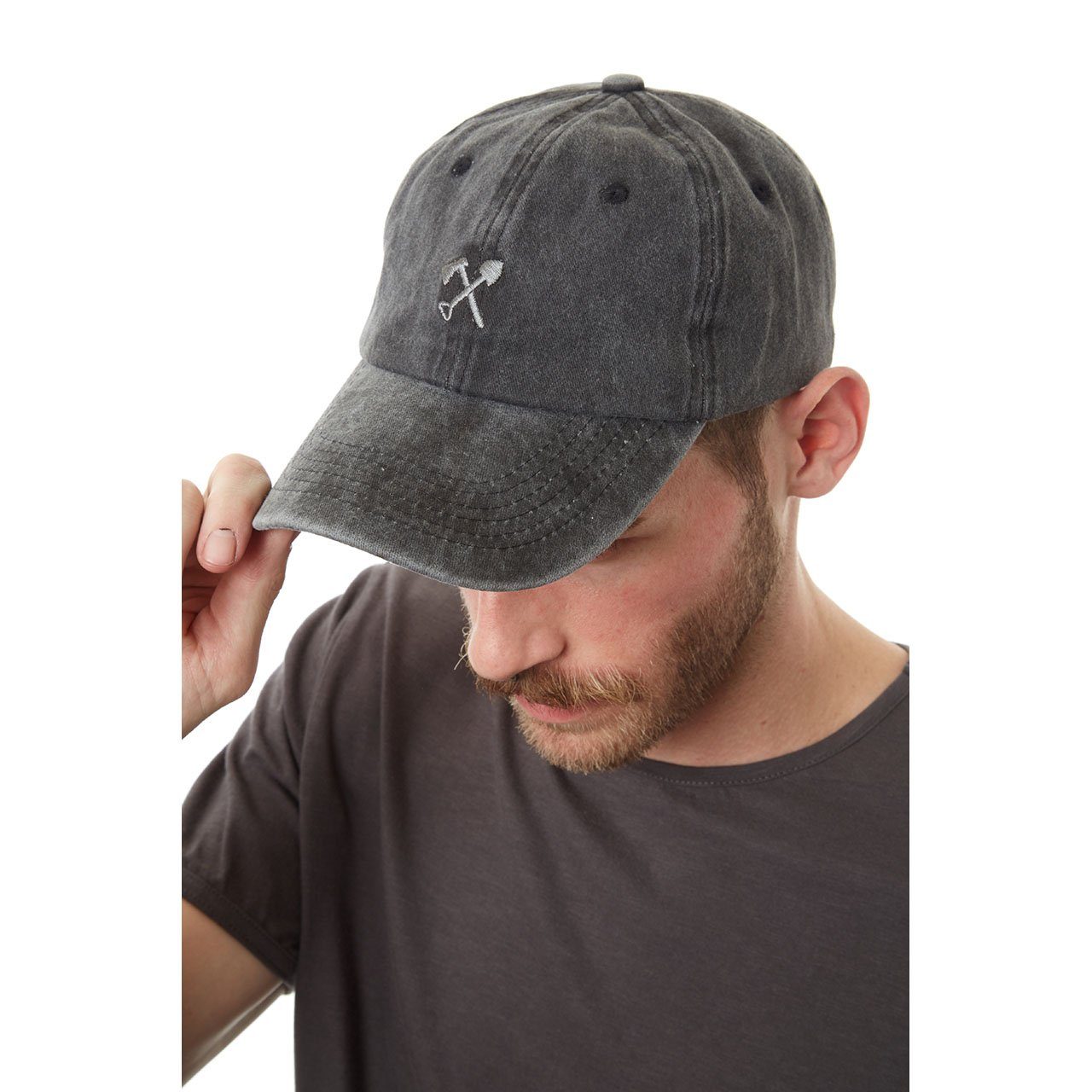 Man wearing a gray baseball cap with a logo on a white background