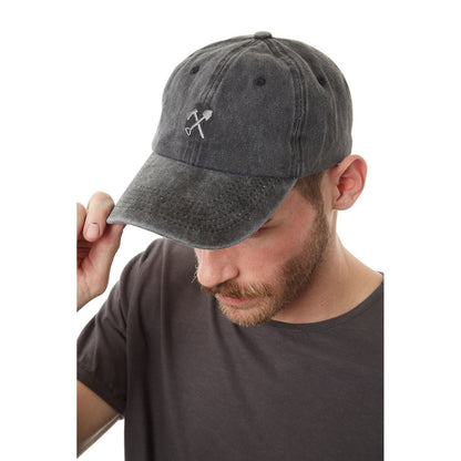 Man wearing a gray baseball cap with a logo on a white background