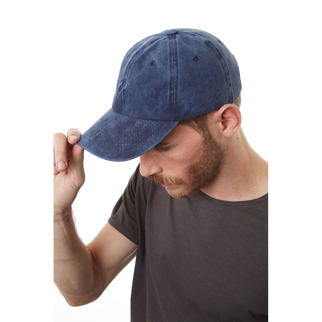 Man wearing a blue denim cap on a white background