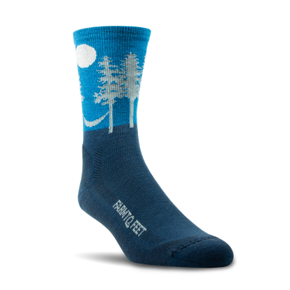 Blue sock with white tree and moon design on a white background