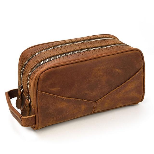 Brown genuine leather travel toiletry bag with dual zippers and side strap