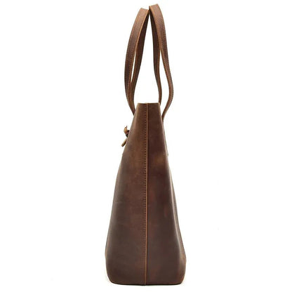 Handcrafted leather tote bag with long shoulder strap and tapered top silhouette