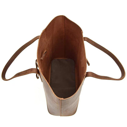 Leather tote bag interior view with open top and side pockets, brown lining