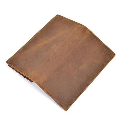 Brown leather pocket book folded closed with single stitched edge