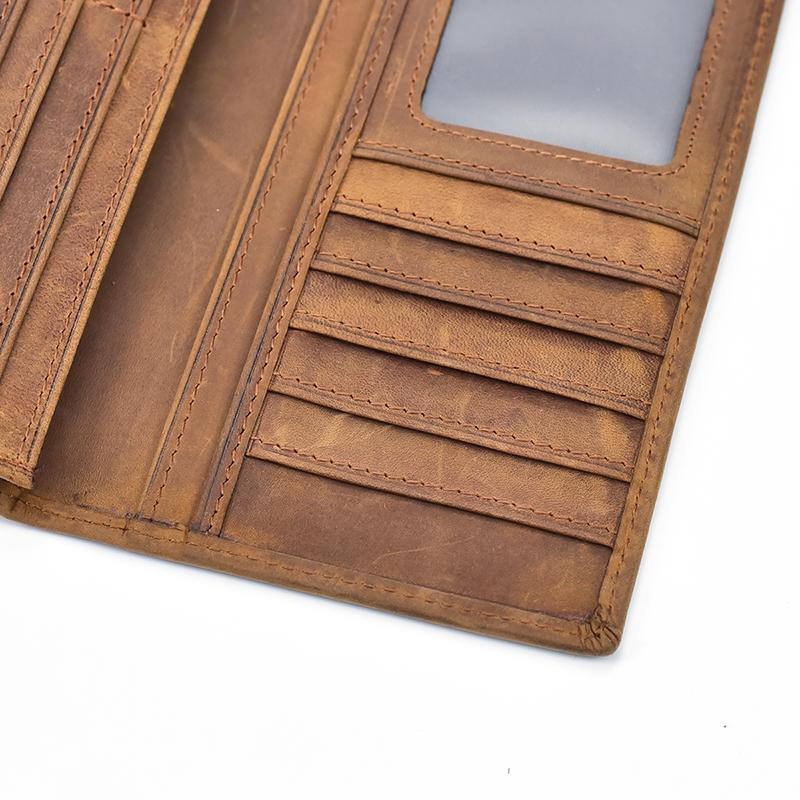 Close-up of brown leather pocket book interior with card slots and stitching