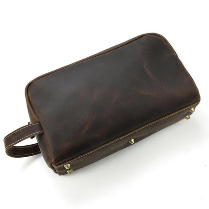 Dark brown genuine leather toiletry bag with side strap and brass zipper hardware