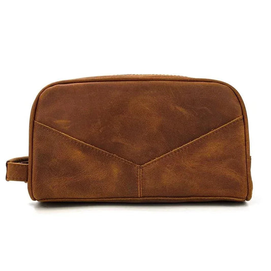 Brown leather travel toiletry bag with top zipper and stitched panels
