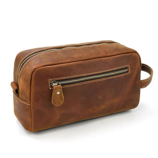 Brown genuine leather toiletry bag front view with top zip and hanging leather tab