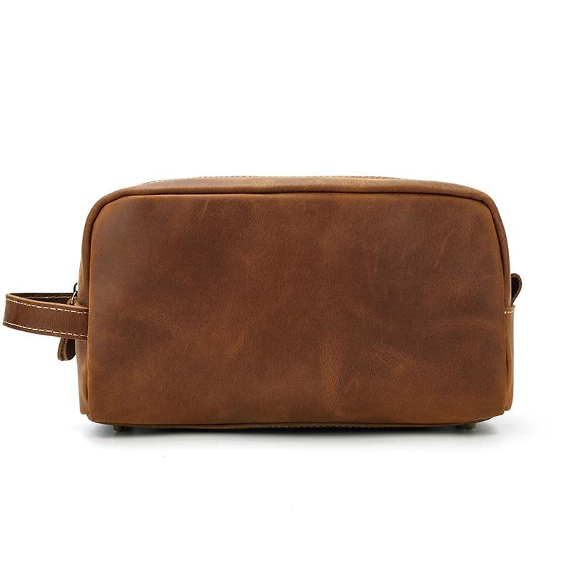 Brown genuine leather toiletry bag with zip top and compact rounded profile