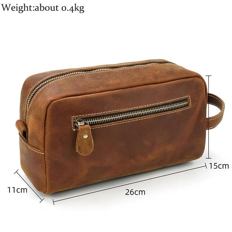 Brown genuine leather toiletry bag with front zip pocket and top carry strap