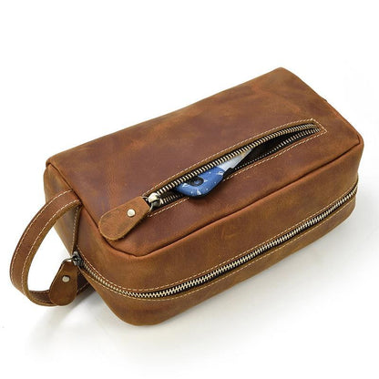 Brown genuine leather toiletry bag with top zipper and front tab detail