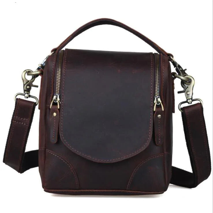Small brown leather camera bag with front flap and adjustable crossbody shoulder straps