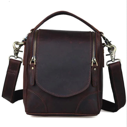 Small brown leather camera bag with front flap and adjustable crossbody shoulder straps