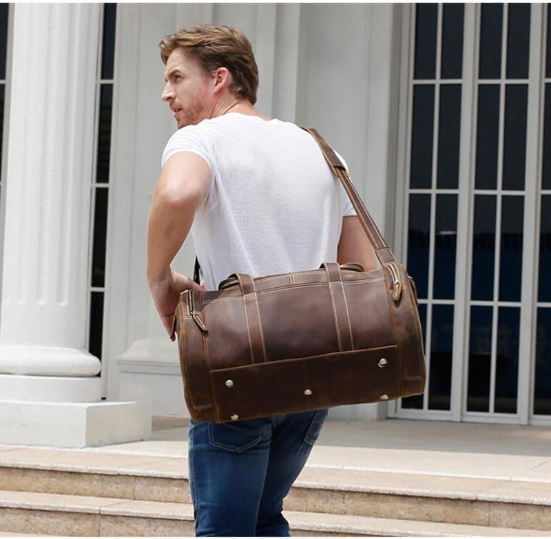Brown leather weekender duffel bag with rear panel details and top handle.