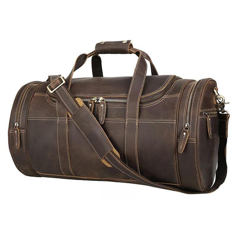 Vintage brown leather weekender duffel bag with top handle, crossbody strap, and zip pockets.