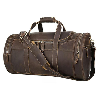Vintage brown leather weekender duffel bag with top handle, crossbody strap, and zip pockets.