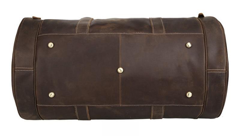 Brown leather round duffle bag back with stitched seams and riveted end panel.