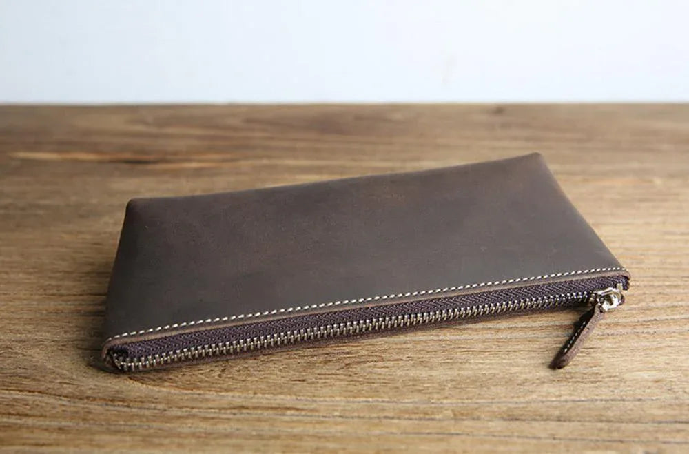 Dark brown leather pencil case with long zipper and leather zipper pull