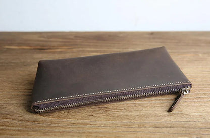 Dark brown leather pencil case with long zipper and leather zipper pull