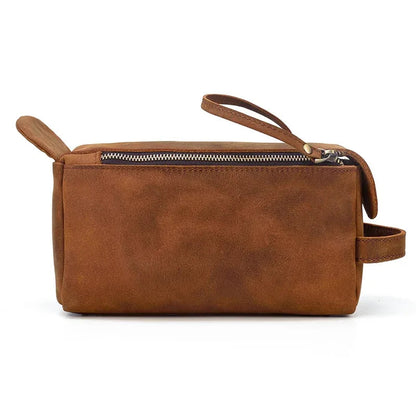 Compact brown leather toiletry bag with top zip and carrying handle