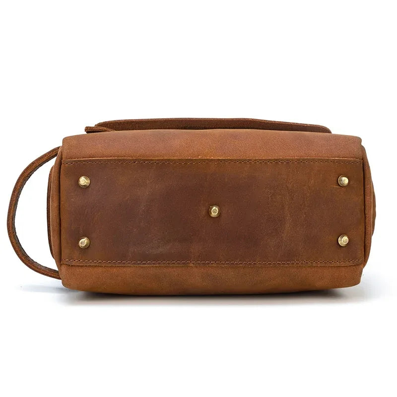 Leather toiletry bag with back facing panel and brass hardware rivets