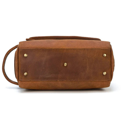 Leather toiletry bag with back facing panel and brass hardware rivets