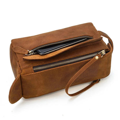 Leather toiletry bag with two zippers and visible interior lining through open top