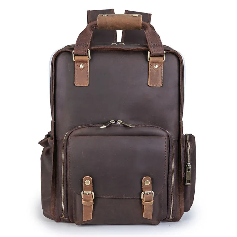 Dark brown leather camera backpack front view with dual zip pockets