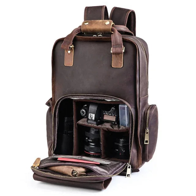 Brown leather camera backpack open top showing interior camera gear compartments