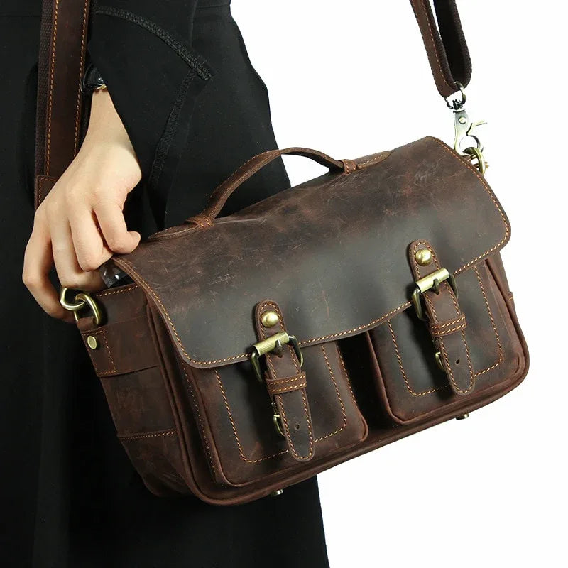Dark brown leather crossbody messenger bag with front flap and buckle straps