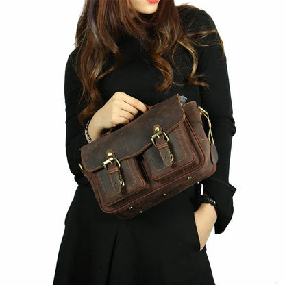 Dark brown crossbody messenger bag carried by model with front buckle flap