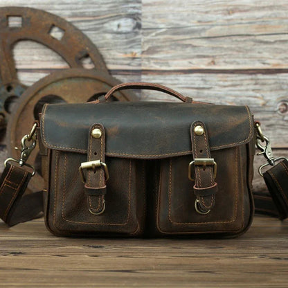 Dark brown leather crossbody bag with front flap, two buckle straps, and side hooks