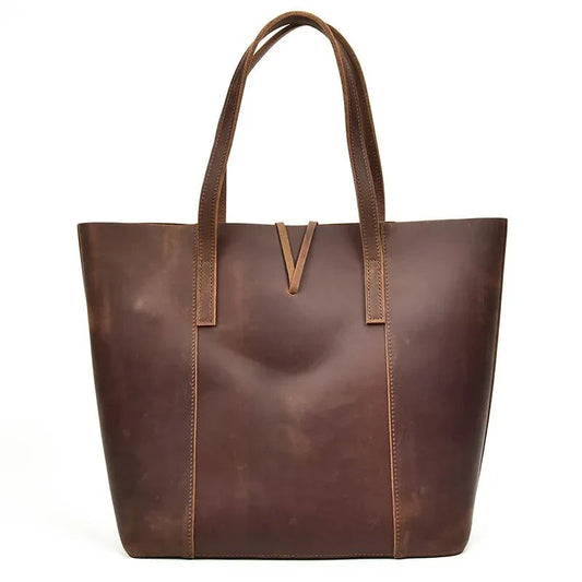 Handcrafted leather tote bag with long handles and front V-shaped strap detail
