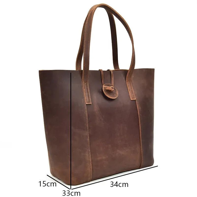 Handcrafted leather tote bag with dual handles and front clasp detail, dark brown
