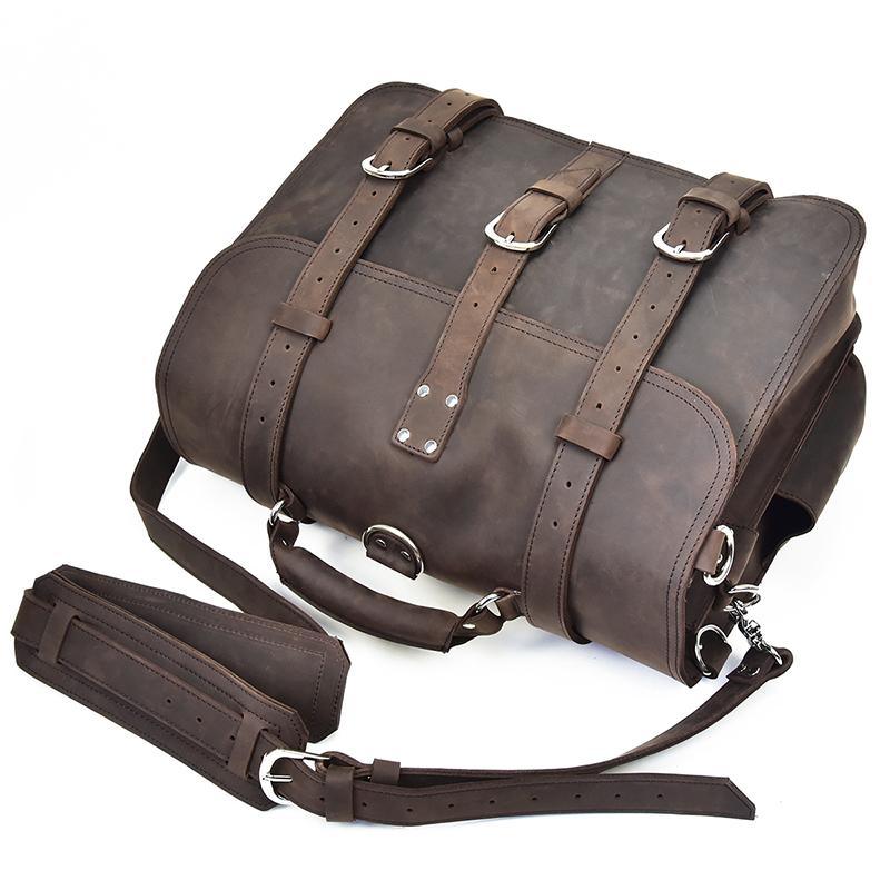 Dark brown leather messenger bag with front straps, side buckles, and crossbody strap
