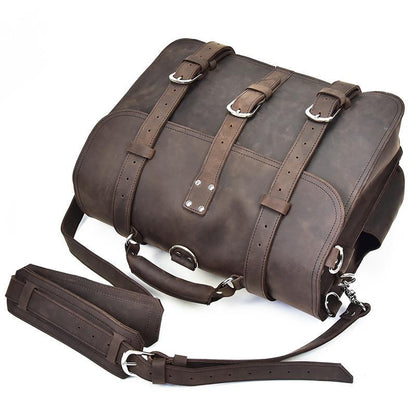 Dark brown leather messenger bag with front straps, side buckles, and crossbody strap