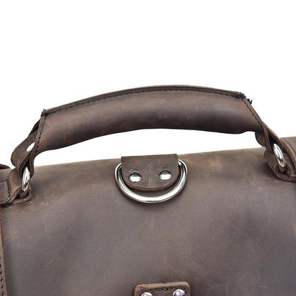 Dark brown leather messenger bag handle with oval metal clasp on top