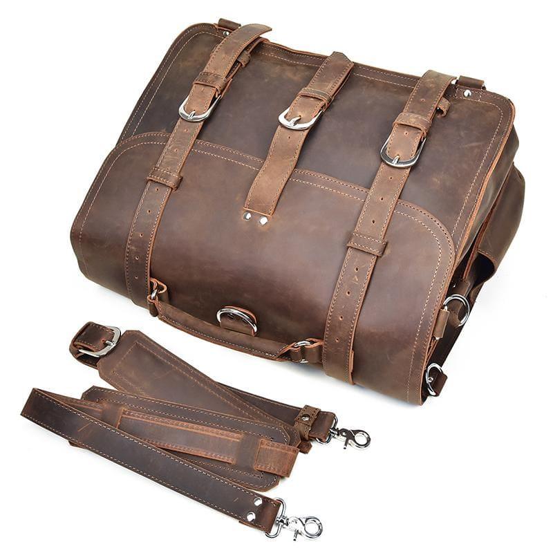 Brown leather messenger bag with front buckle straps and a matching hanging strap.