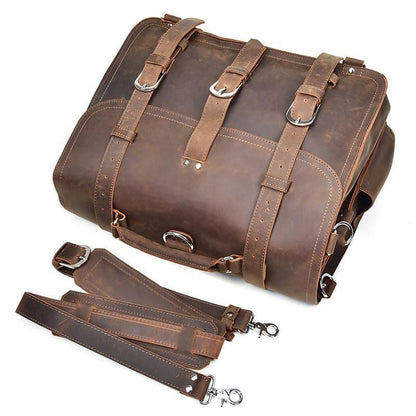 Brown leather messenger bag with front buckle straps and a matching hanging strap.