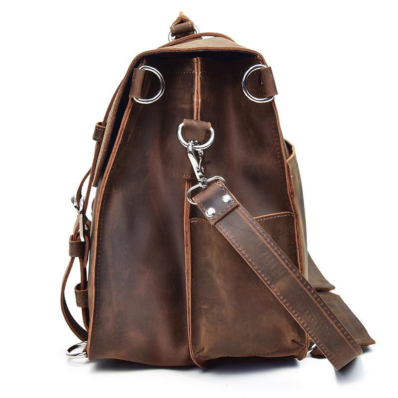 Brown leather messenger bag with side crossbody strap and metal key clasp on front.