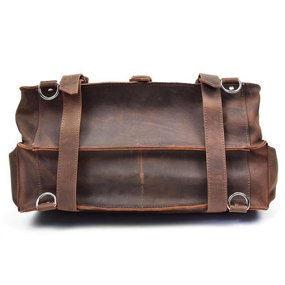 Brown vintage leather messenger bag with dual front straps and metal rings.