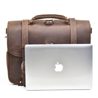 Brown leather messenger bag with laptop in front pocket and adjustable shoulder straps.