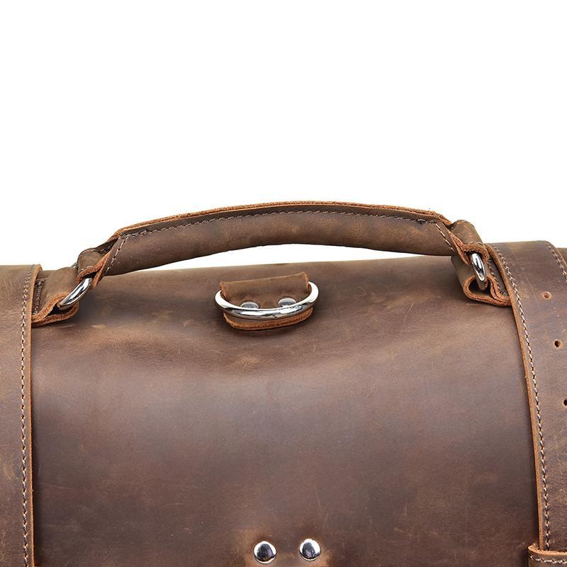 Vintage dark brown leather messenger bag with curved handle and metal D-ring hardware
