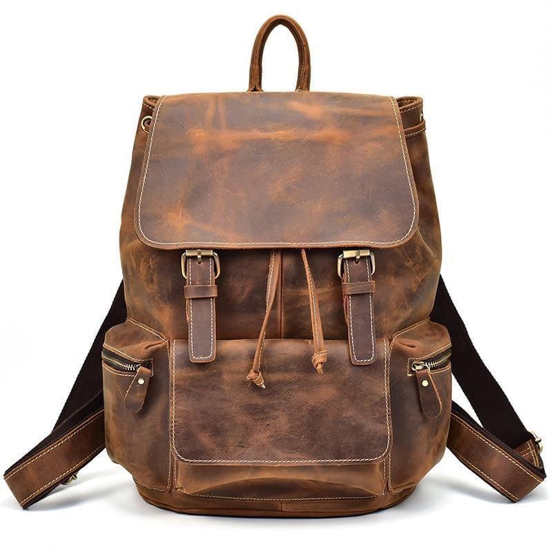Brown vintage leather backpack with front flap, two side pockets, and adjustable straps.