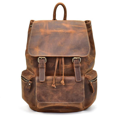 Brown vintage leather backpack with top flap, front buckles, and drawstring cords.