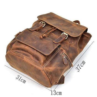 Vintage leather backpack in brown with top flap, buckle straps, and zip pocket