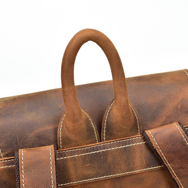Vintage leather backpack with top handle and stitched seams, distressed brown leather