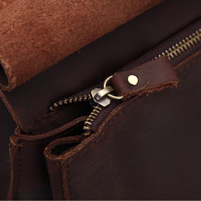 Leather zipper pull with metal clip and brass-toned snap tab