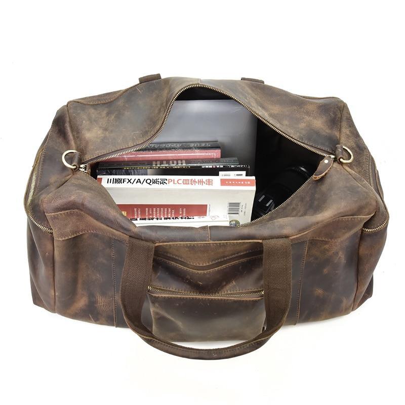 Distressed dark brown leather duffle bag open top with interior pockets and zipper trim