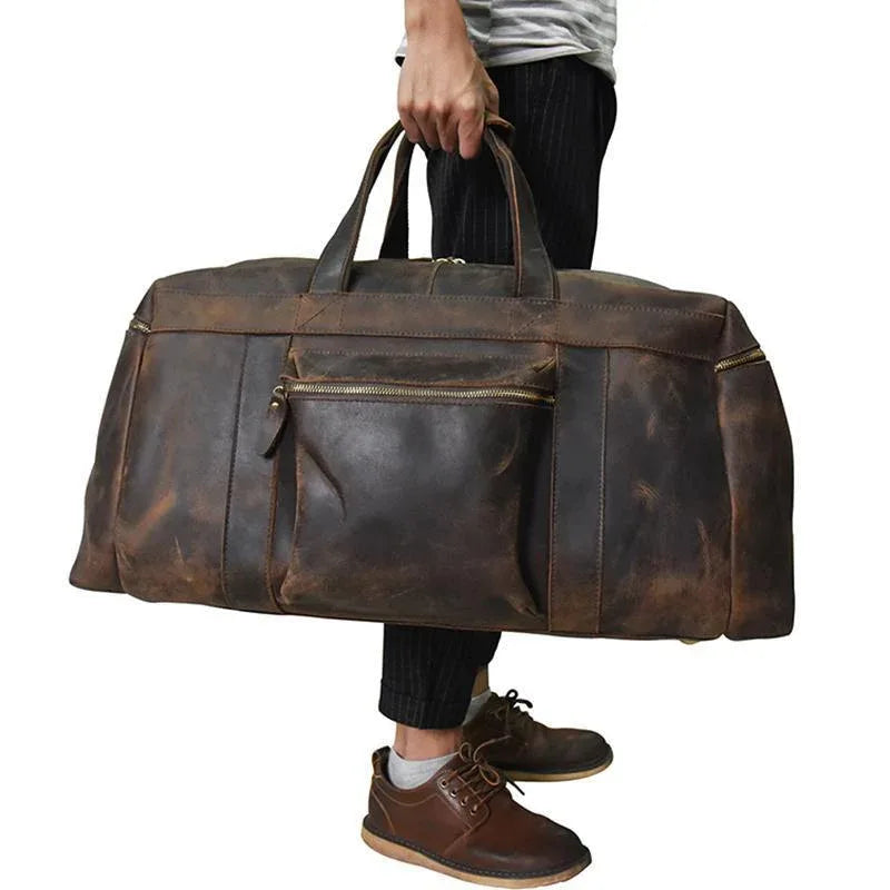 Distressed dark brown leather large duffle bag with top handles and zipper front pocket